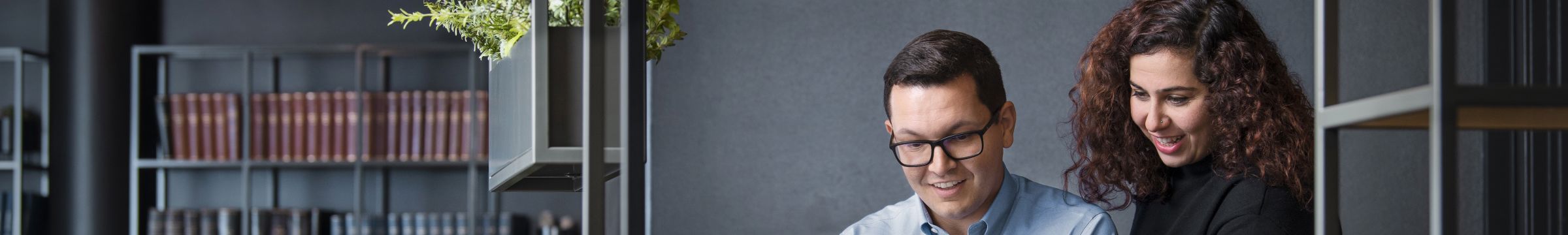 Female and male employees smiling