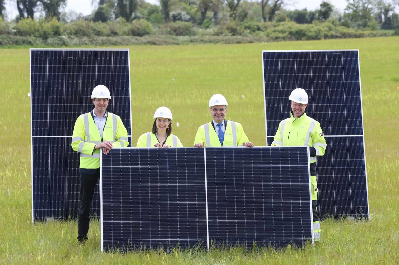 Minister Dara Calleary and Kevin O'Donovan holding up solar panels 